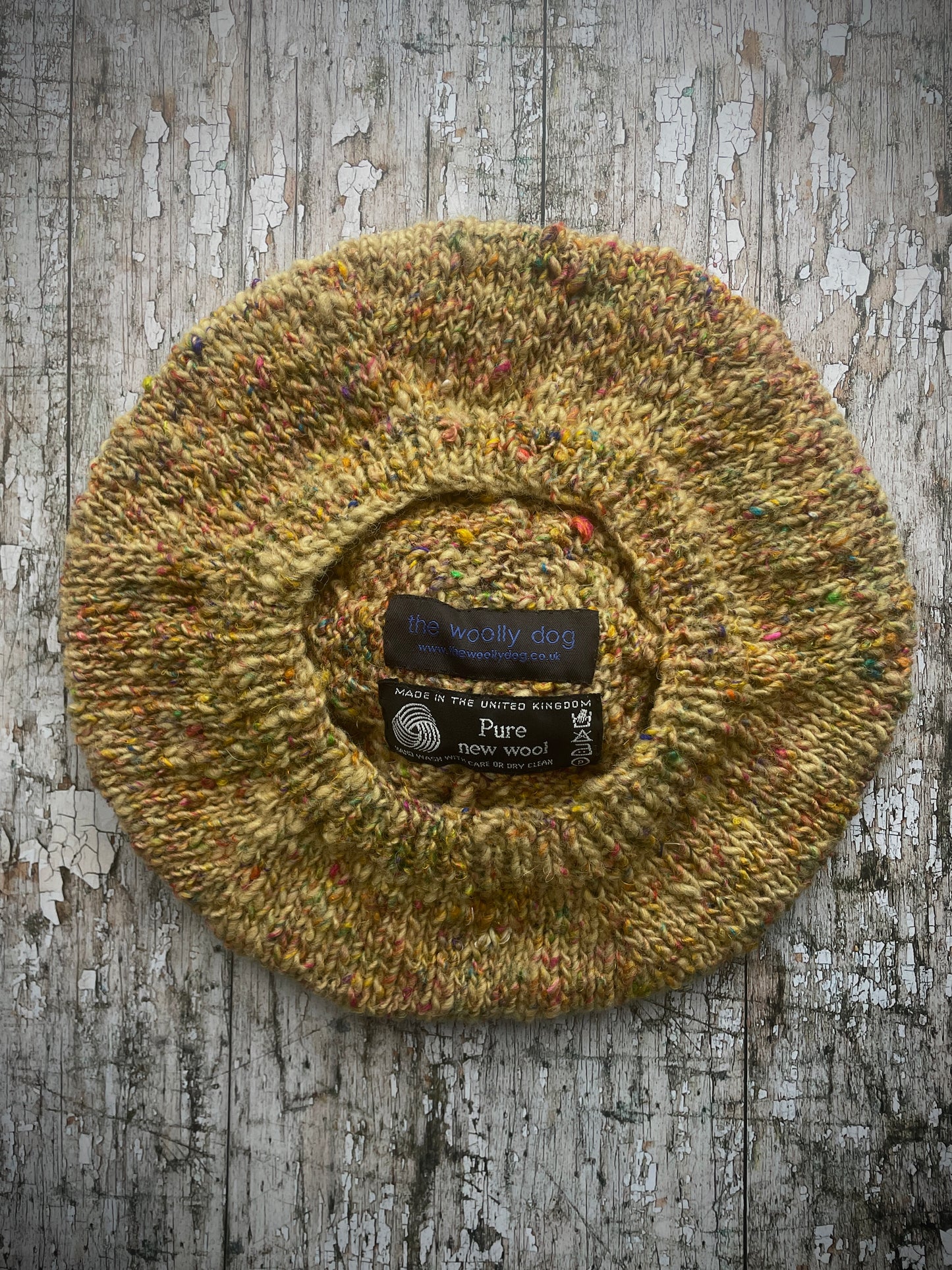 Small Hand Knitted Wool Beret In Ochre

Beautifully hand knitted beret using hand spun British Shetland pure wool, which has been hand dyed with organically grown silver birch leaves. It was then spun with recycled silk fibres to add multi coloured flecks. The main colour of the beret is a mustard ochre yellow. It has a ribbed band that gives the hat a snug fit and a big pom of the Shetland wool and a garnet coloured Lettlopi wool. Perfect for keeping your head warm on cold days.