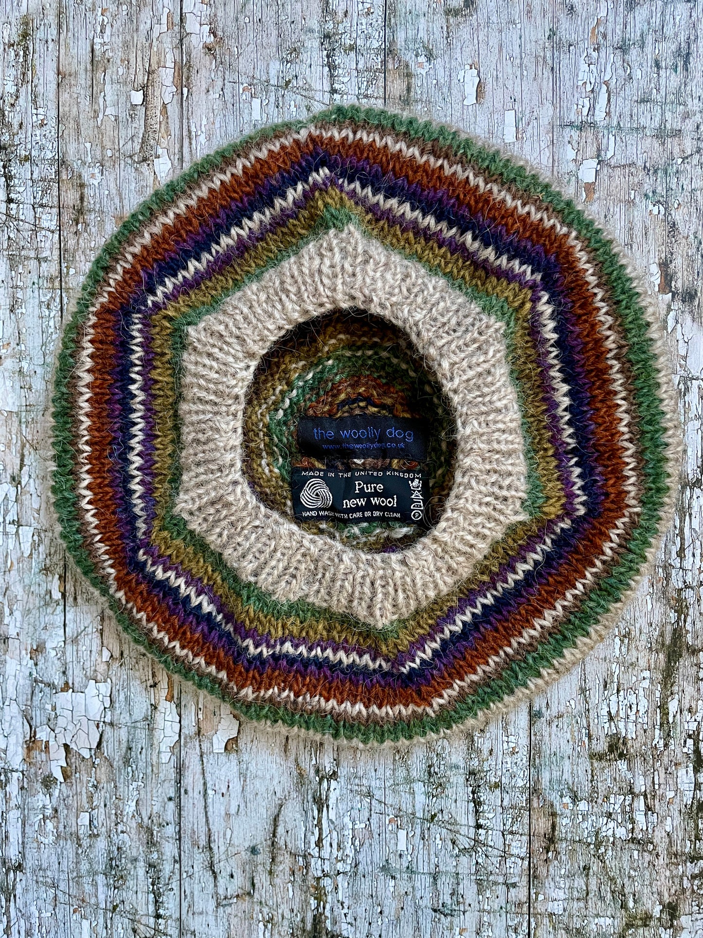 Beautifully hand knitted beret in Icelandic wool, perfect for keeping your head warm on cold days and adding a touch of 40's style to any outfit. Knitted in oat, sage green heather, dark kelp, violet heather, navy, burnt orange and milk chocolate stripes, with a green heather ribbed band that gives the hat a snug fit.

SIZE: adult.

CARE: hand wash or machine wash on wool cycle at 30 degrees, dry flat, do not tumble dry.