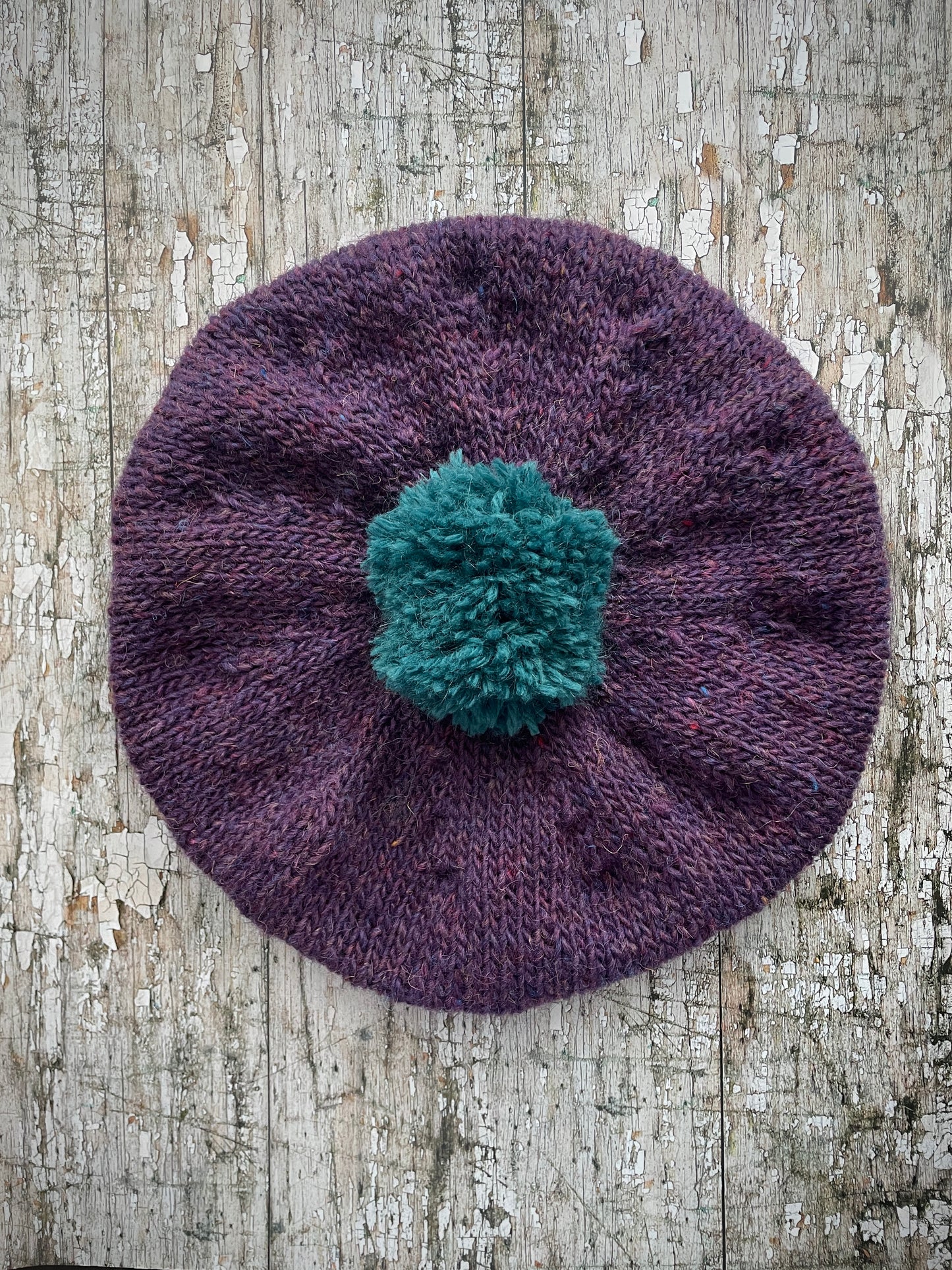 Hand Knitted Wool Beret Violet Heather + Viridian

Beautifully hand knitted beret in Icelandic pure wool, perfect for keeping your head warm on cold days. Knitted in a beautiful violet heather with a big viridian pom and viridian ribbed band that gives the hat a snug fit.

SIZE: adult.

DIAMETER: 11" / 28cm.

CARE: hand wash or machine wash on wool cycle at 30 degrees, dry flat, do not tumble dry.