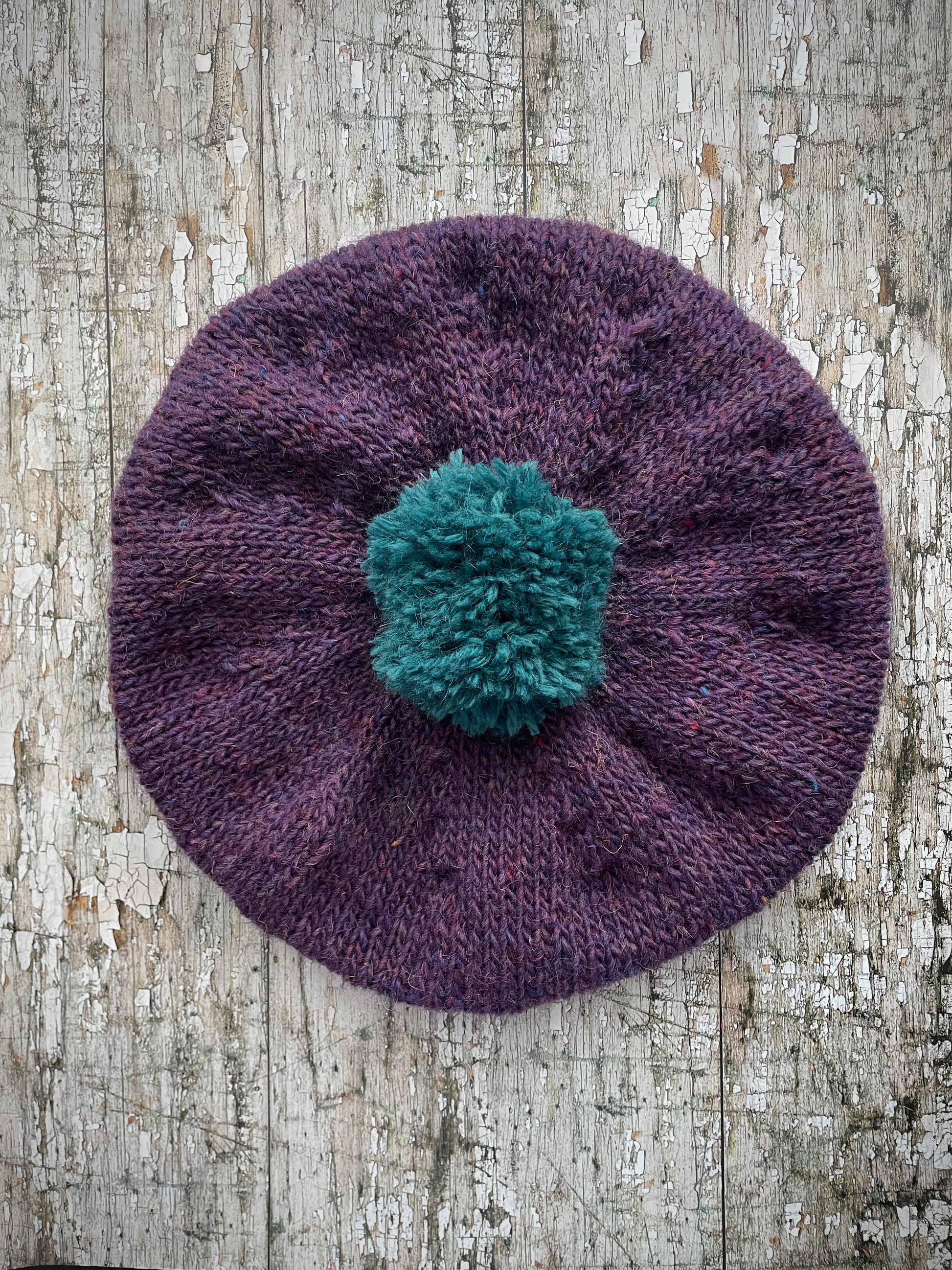 Hand Knitted Wool Beret Violet Heather + Viridian

Beautifully hand knitted beret in Icelandic pure wool, perfect for keeping your head warm on cold days. Knitted in a beautiful violet heather with a big viridian pom and viridian ribbed band that gives the hat a snug fit.

SIZE: adult.

DIAMETER: 11" / 28cm.

CARE: hand wash or machine wash on wool cycle at 30 degrees, dry flat, do not tumble dry.