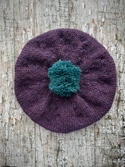 Hand Knitted Wool Beret Violet Heather + Viridian

Beautifully hand knitted beret in Icelandic pure wool, perfect for keeping your head warm on cold days. Knitted in a beautiful violet heather with a big viridian pom and viridian ribbed band that gives the hat a snug fit.

SIZE: adult.

DIAMETER: 11" / 28cm.

CARE: hand wash or machine wash on wool cycle at 30 degrees, dry flat, do not tumble dry.