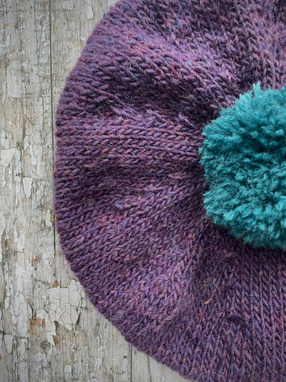 Hand Knitted Wool Beret Violet Heather + Viridian

Beautifully hand knitted beret in Icelandic pure wool, perfect for keeping your head warm on cold days. Knitted in a beautiful violet heather with a big viridian pom and viridian ribbed band that gives the hat a snug fit.

SIZE: adult.

DIAMETER: 11" / 28cm.

CARE: hand wash or machine wash on wool cycle at 30 degrees, dry flat, do not tumble dry.