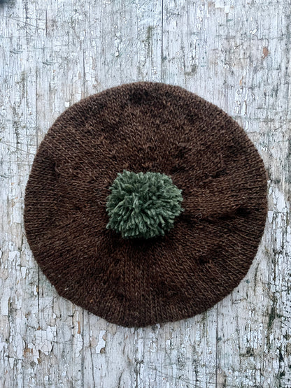 Hand Knitted Wool Beret Dark Chocolate + Sage Green Heather

Beautifully hand knitted beret in Icelandic pure wool, perfect for keeping your head warm on cold days. Knitted in a lovely dark chocolate brown colour with a sage green pom and ribbed band that gives the hat a snug fit.

SIZE: adult.

CARE: hand wash or machine wash on wool cycle at 30 degrees, dry flat, do not tumble dry.
