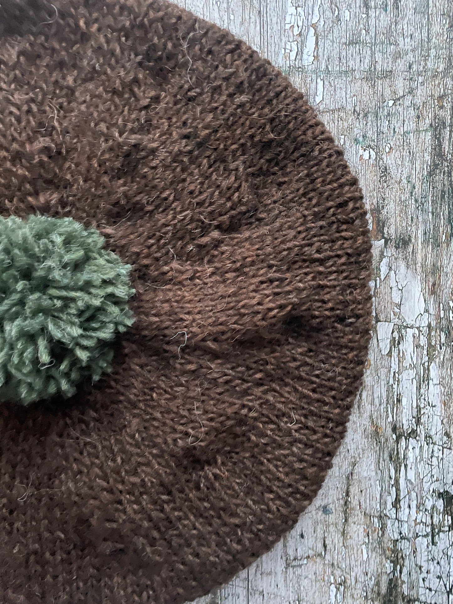 Hand Knitted Wool Beret Dark Chocolate + Sage Green Heather

Beautifully hand knitted beret in Icelandic pure wool, perfect for keeping your head warm on cold days. Knitted in a lovely dark chocolate brown colour with a sage green pom and ribbed band that gives the hat a snug fit.

SIZE: adult.

CARE: hand wash or machine wash on wool cycle at 30 degrees, dry flat, do not tumble dry.