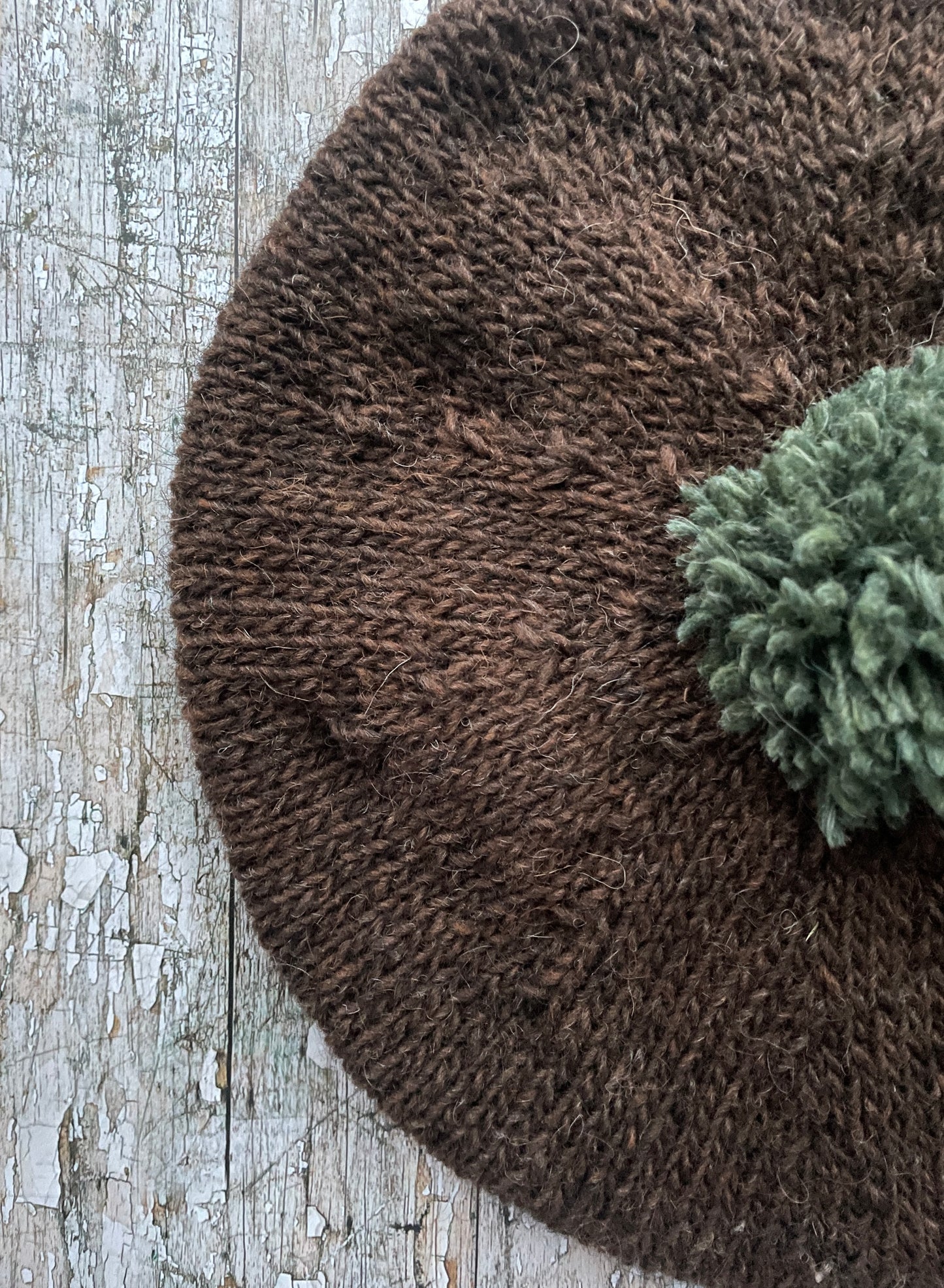 Hand Knitted Wool Beret Dark Chocolate + Sage Green Heather

Beautifully hand knitted beret in Icelandic pure wool, perfect for keeping your head warm on cold days. Knitted in a lovely dark chocolate brown colour with a sage green pom and ribbed band that gives the hat a snug fit.

SIZE: adult.

CARE: hand wash or machine wash on wool cycle at 30 degrees, dry flat, do not tumble dry.