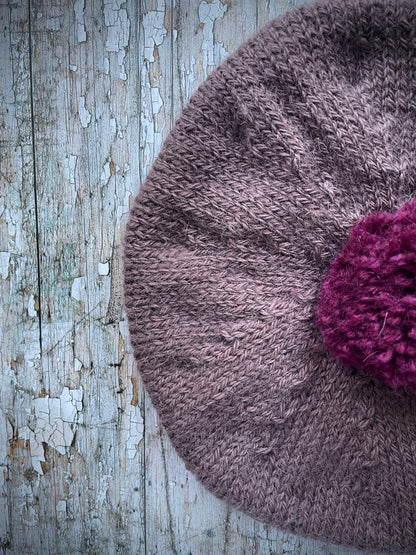 Hand Knitted Wool Beret In Umber + Mulberry

Beautifully hand knitted beret with West Yorkshire Spinners wool, alpaca and mohair in an umber colour, perfect for keeping your head warm on cold days, with a big pom and ribbed band that gives the hat a snug fit in a mix of Rowan wool and mohair in mulberry

SIZE: adult.

CARE: hand wash or machine wash on wool cycle at 30 degrees, dry flat, do not tumble dry.