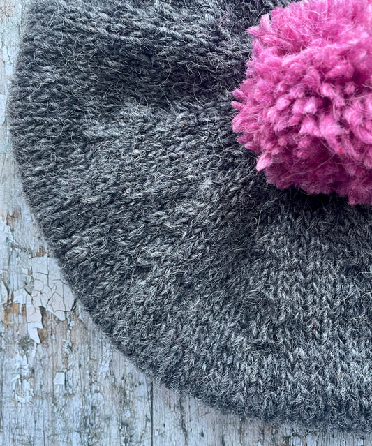 Hand Knitted Wool Beret Grey Tweed + Pink Heather

Beautifully hand knitted beret in Icelandic pure wool, perfect for keeping your head warm on cold days. Knitted in a grey tweed, with a big pink pom and pink ribbed band that gives the hat a snug fit.

SIZE: adult.

CARE: hand wash or machine wash on wool cycle at 30 degrees, dry flat, do not tumble dry.