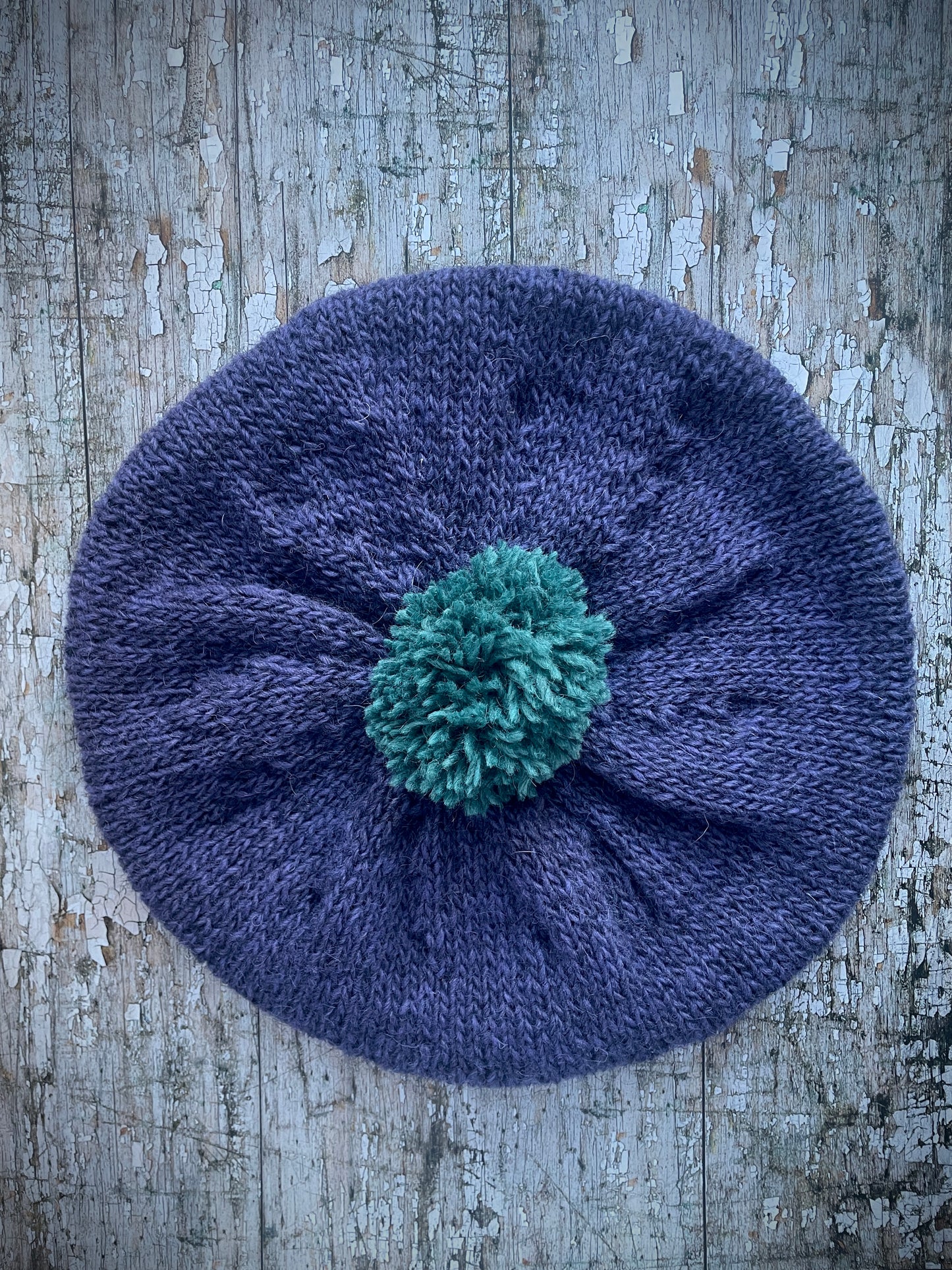 Hand Knitted Wool Lavender + Viridian Beret

Beautifully hand knitted beret in Icelandic pure wool, perfect for keeping your head warm on cold days. Knitted in a deep lavender, with a big viridian pom and a ribbed band that gives the hat a snug fit.

SIZE: adult.

CARE: hand wash or machine wash on wool cycle at 30 degrees, dry flat, do not tumble dry.
