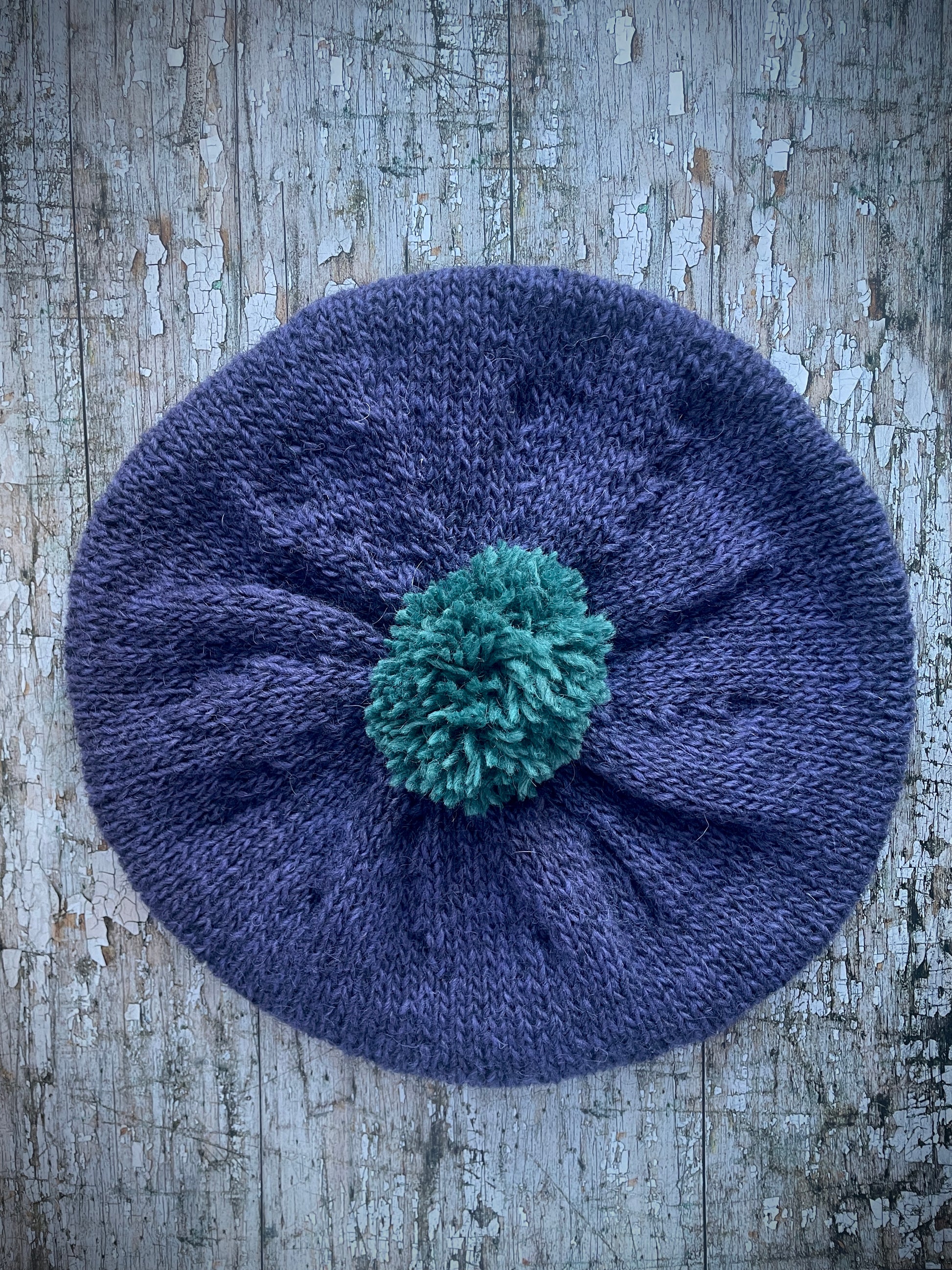 Hand Knitted Wool Lavender + Viridian Beret

Beautifully hand knitted beret in Icelandic pure wool, perfect for keeping your head warm on cold days. Knitted in a deep lavender, with a big viridian pom and a ribbed band that gives the hat a snug fit.

SIZE: adult.

CARE: hand wash or machine wash on wool cycle at 30 degrees, dry flat, do not tumble dry.