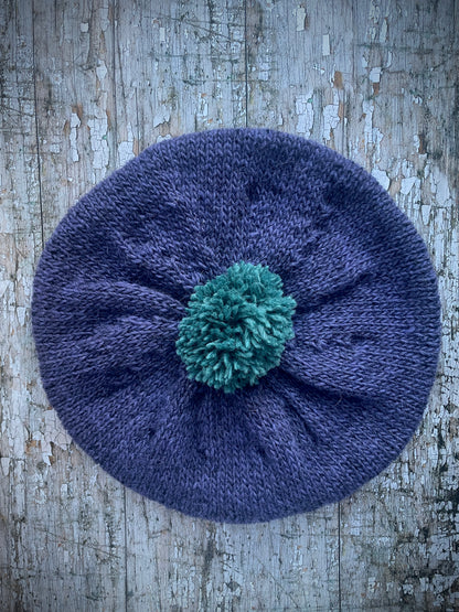 Hand Knitted Wool Lavender + Viridian Beret

Beautifully hand knitted beret in Icelandic pure wool, perfect for keeping your head warm on cold days. Knitted in a deep lavender, with a big viridian pom and a ribbed band that gives the hat a snug fit.

SIZE: adult.

CARE: hand wash or machine wash on wool cycle at 30 degrees, dry flat, do not tumble dry.
