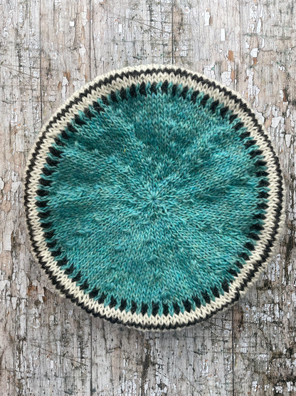 Hand Knitted Wool Beret Aqua

Beautifully hand knitted beret in Icelandic pure wool, perfect for keeping your head warm on cold days, knitted in a pretty aqua colour, with a&nbsp; pattern of graphite and white and a ribbed band that gives the hat a snug fit.

SIZE: adult.

DIAMETER: 11+1/4" / 28.5cm.

CARE: hand wash or machine wash on wool cycle at 30 degrees, dry flat, do not tumble dry.