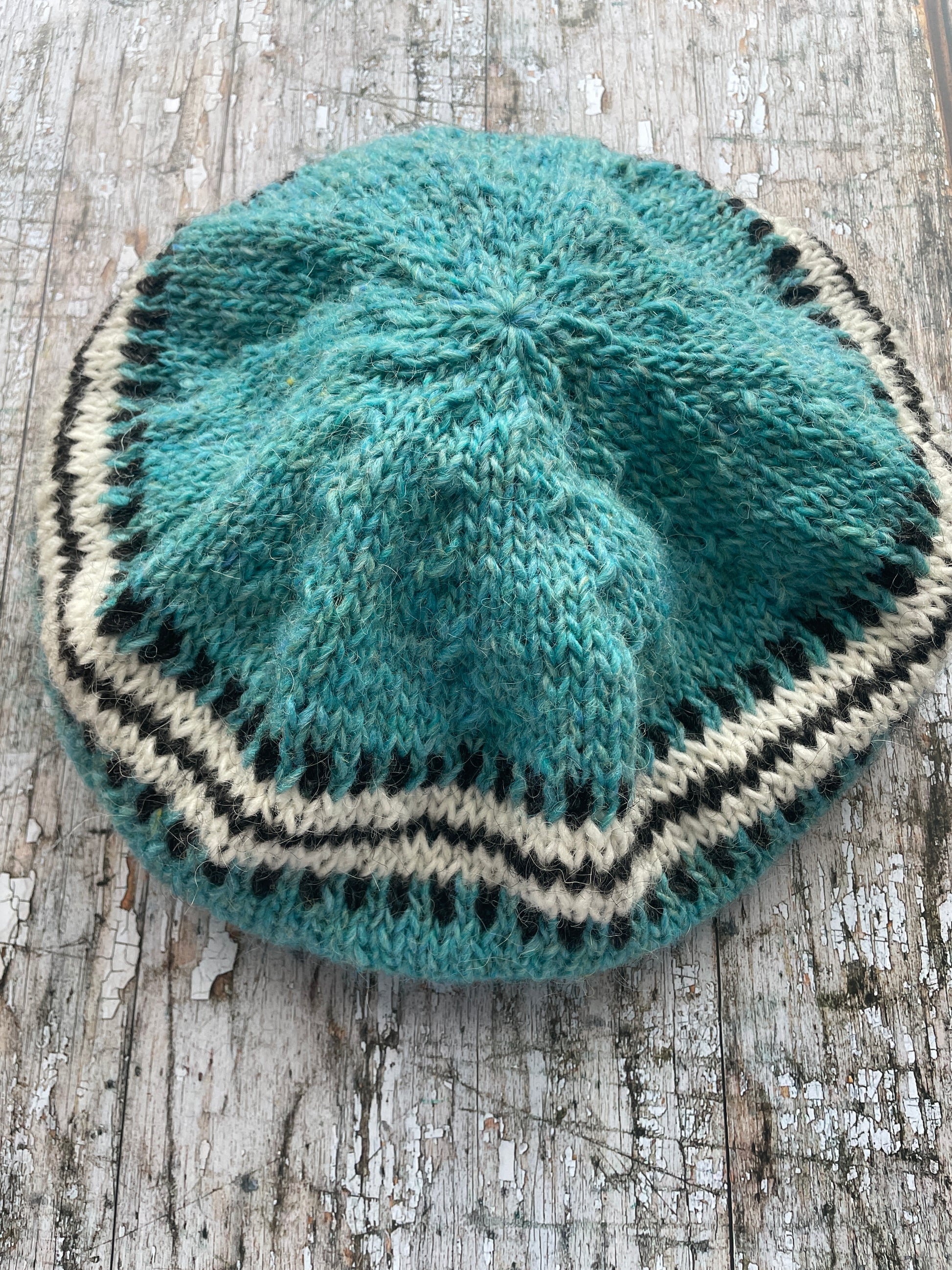 Hand Knitted Wool Beret Aqua

Beautifully hand knitted beret in Icelandic pure wool, perfect for keeping your head warm on cold days, knitted in a pretty aqua colour, with a&nbsp; pattern of graphite and white and a ribbed band that gives the hat a snug fit.

SIZE: adult.

DIAMETER: 11+1/4" / 28.5cm.

CARE: hand wash or machine wash on wool cycle at 30 degrees, dry flat, do not tumble dry.