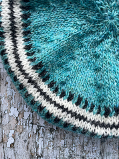 Hand Knitted Wool Beret Aqua

Beautifully hand knitted beret in Icelandic pure wool, perfect for keeping your head warm on cold days, knitted in a pretty aqua colour, with a&nbsp; pattern of graphite and white and a ribbed band that gives the hat a snug fit. 

SIZE: adult.