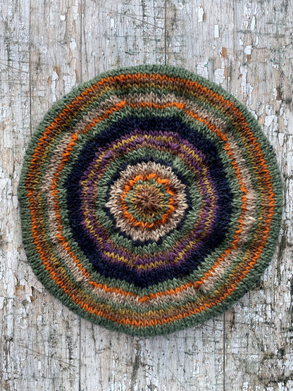 Beautifully hand knitted beret in Icelandic wool, perfect for keeping your head warm on cold days and adding a touch of 40's style to any outfit. Knitted in navy, dark oat, green heather, violet heather, kelp, burnt orange and milk chocolate stripes, with a navy ribbed band that gives the hat a snug fit.

SIZE: adult.

DIAMETER: 11+1/2" / 29cm.

CARE: hand wash or machine wash on wool cycle at 30 degrees, dry flat, do not tumble dry.