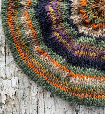 Beautifully hand knitted beret in Icelandic wool, perfect for keeping your head warm on cold days and adding a touch of 40's style to any outfit. Knitted in navy, dark oat, green heather, violet heather, kelp, burnt orange and milk chocolate stripes, with a navy ribbed band that gives the hat a snug fit.

SIZE: adult.

DIAMETER: 11+1/2" / 29cm.

CARE: hand wash or machine wash on wool cycle at 30 degrees, dry flat, do not tumble dry.