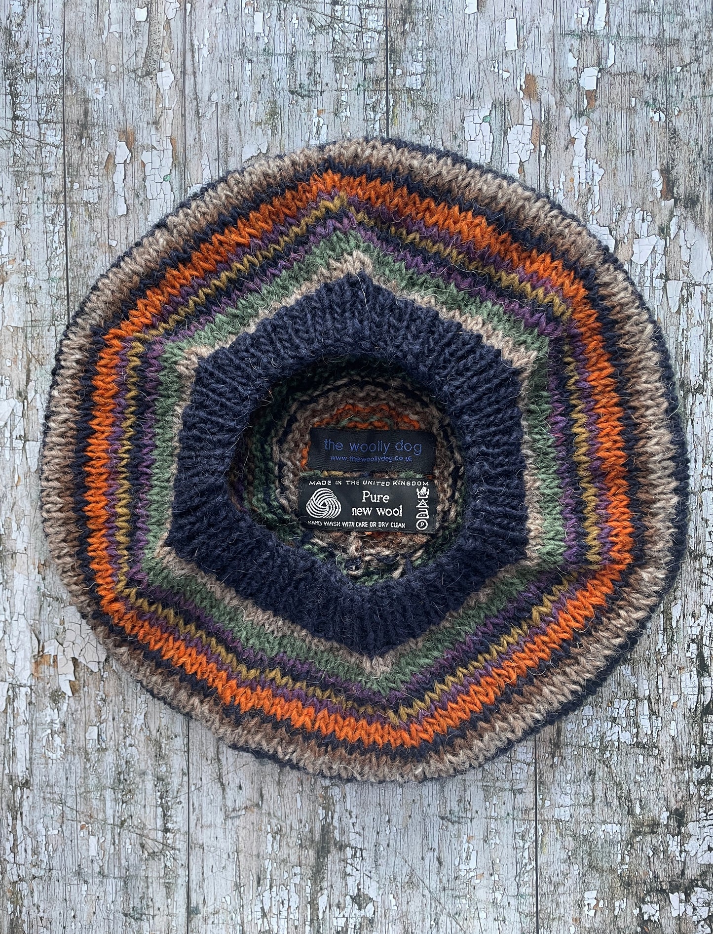 Beautifully hand knitted beret in Icelandic wool, perfect for keeping your head warm on cold days and adding a touch of 40's style to any outfit. Knitted in navy, dark oat, green heather, violet heather, kelp, burnt orange and milk chocolate stripes, with a navy ribbed band that gives the hat a snug fit.

SIZE: adult.

DIAMETER: 11+1/2" / 29cm.

CARE: hand wash or machine wash on wool cycle at 30 degrees, dry flat, do not tumble dry.