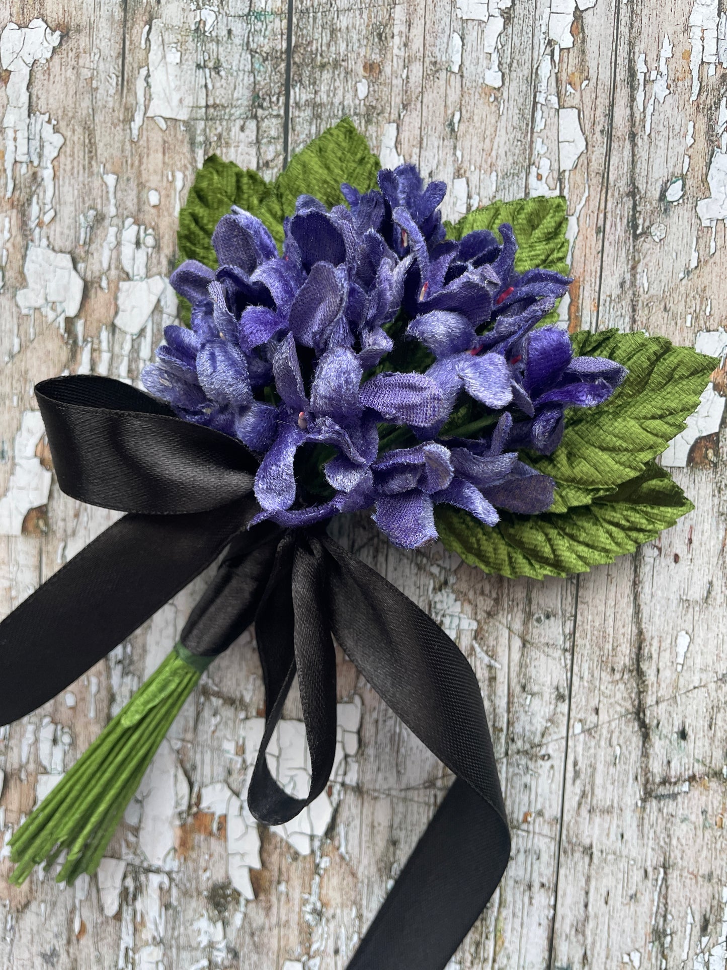 Lavender Violets + Green Leaves Gothic Brooch

This brooch contains unused old stock vintage millinery flowers, therefore like all vintage and antique items they may show slight signs of age.
Perfect as a gift for a vintage fan, dressing up, costumes, display and photo props.

Measurements Approximately:
Width: 12 cm / 4+3/4"
Length: 18 cm / 7"

