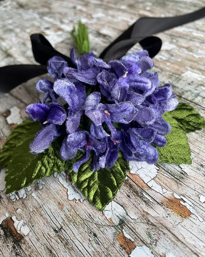 Lavender Violets + Green Leaves Gothic Brooch

This brooch contains unused old stock vintage millinery flowers, therefore like all vintage and antique items they may show slight signs of age.
Perfect as a gift for a vintage fan, dressing up, costumes, display and photo props.

Measurements Approximately:
Width: 12 cm / 4+3/4"
Length: 18 cm / 7"
