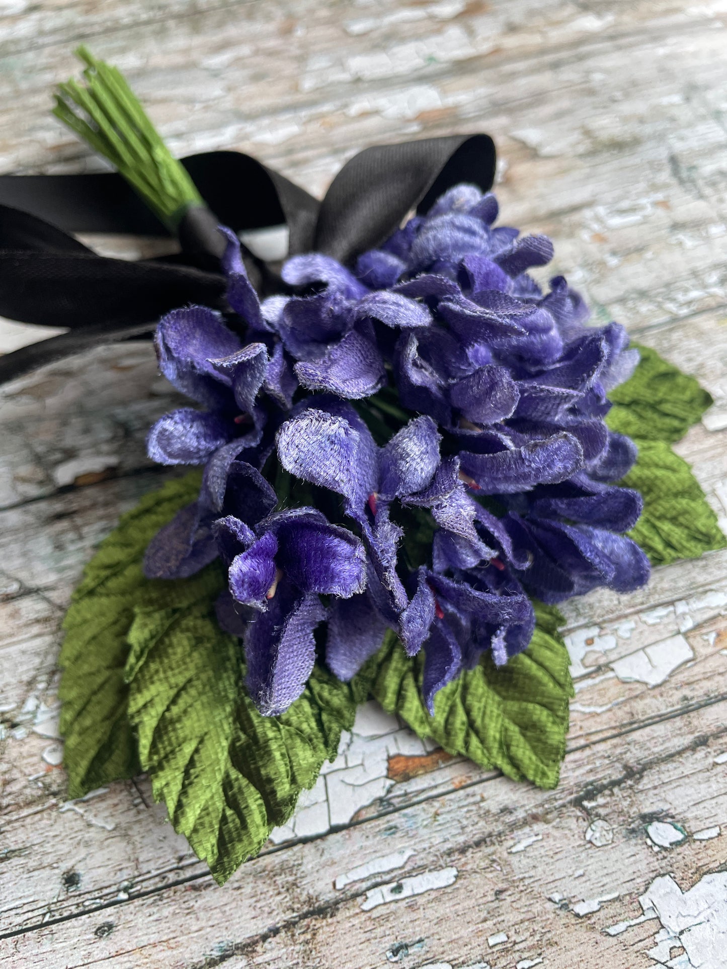 Lavender Violets + Green Leaves Gothic Brooch

This brooch contains unused old stock vintage millinery flowers, therefore like all vintage and antique items they may show slight signs of age.
Perfect as a gift for a vintage fan, dressing up, costumes, display and photo props.

Measurements Approximately:
Width: 12 cm / 4+3/4"
Length: 18 cm / 7"
