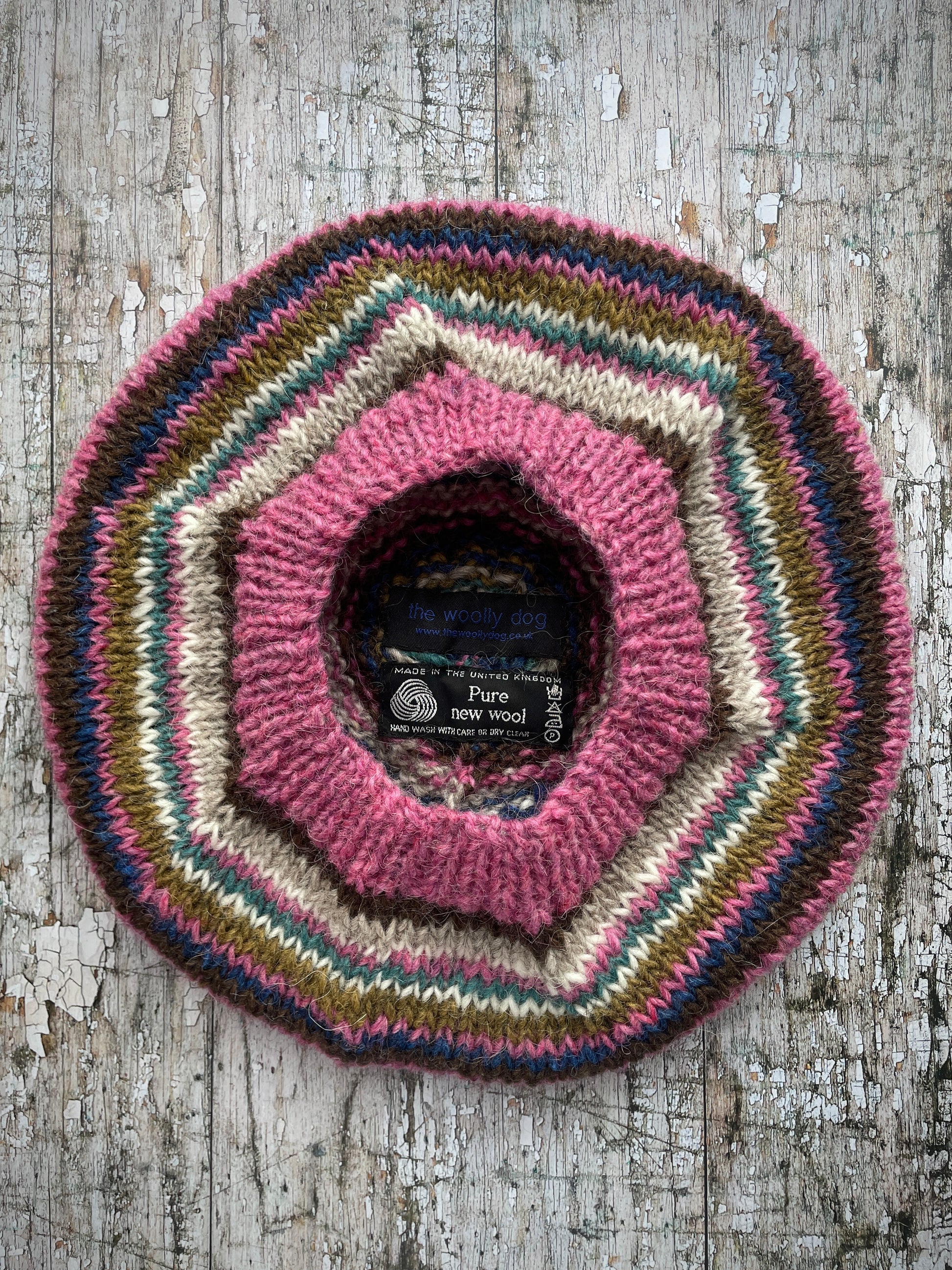 Classic 40's Style Beret no.5
Beautifully hand knitted beret in Icelandic wool, perfect for keeping your head warm on cold days and adding a touch of 40's style to any outfit. Knitted in pink heather, dark chocolate, oat, white, viridian, dark kelp and indigo stripes, with a pink heather ribbed band that gives the hat a snug fit.

SIZE: adult.

DIAMETER: 11+1/4" / 28.5cm.&nbsp;

CARE: hand wash or machine wash on wool cycle at 30 degrees, dry flat, do not tumble dry.