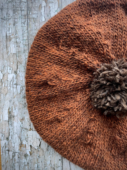 Hand Knitted Wool Beret Paprika + Dark Chocolate

Beautifully hand knitted beret in Icelandic pure wool, perfect for keeping your head warm on cold days, knitted in vibrant paprika colour, with a dark chocolate pom and ribbed band that gives the hat a snug fit.

SIZE: adult.

DIAMETER: 11" / 28cm.

CARE: hand wash or machine wash on wool cycle at 30 degrees, dry flat, do not tumble dry.
