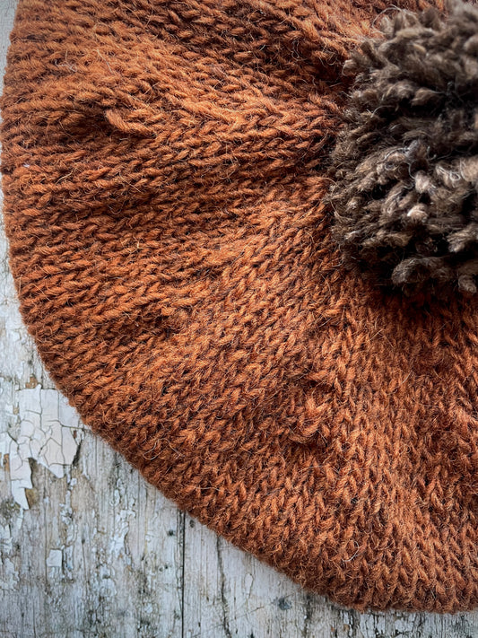 Hand Knitted Wool Beret Paprika + Dark Chocolate

Beautifully hand knitted beret in Icelandic pure wool, perfect for keeping your head warm on cold days, knitted in vibrant paprika colour, with a dark chocolate pom and ribbed band that gives the hat a snug fit.

SIZE: adult.

DIAMETER: 11" / 28cm.

CARE: hand wash or machine wash on wool cycle at 30 degrees, dry flat, do not tumble dry.