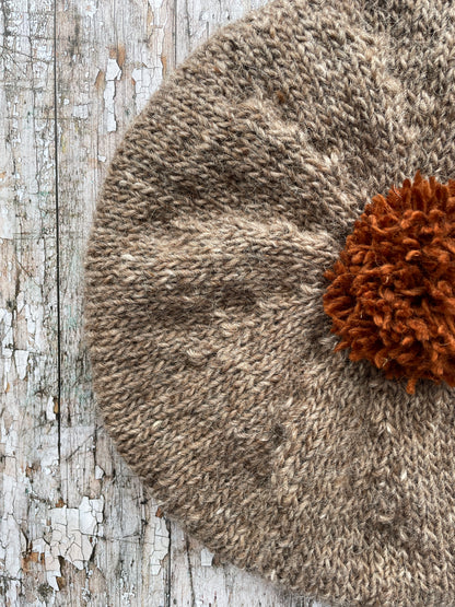 Hand Knitted Wool Beret Dark Oat + Paprika

Beautifully hand knitted beret in Icelandic pure wool, perfect for keeping your head warm on cold days, knitted in dark oat with a vibrant paprika pom and ribbed band that gives the hat a snug fit.

SIZE: adult.

DIAMETER: 11+1/2" / 29cm.

CARE: hand wash or machine wash on wool cycle at 30 degrees, dry flat, do not tumble dry.