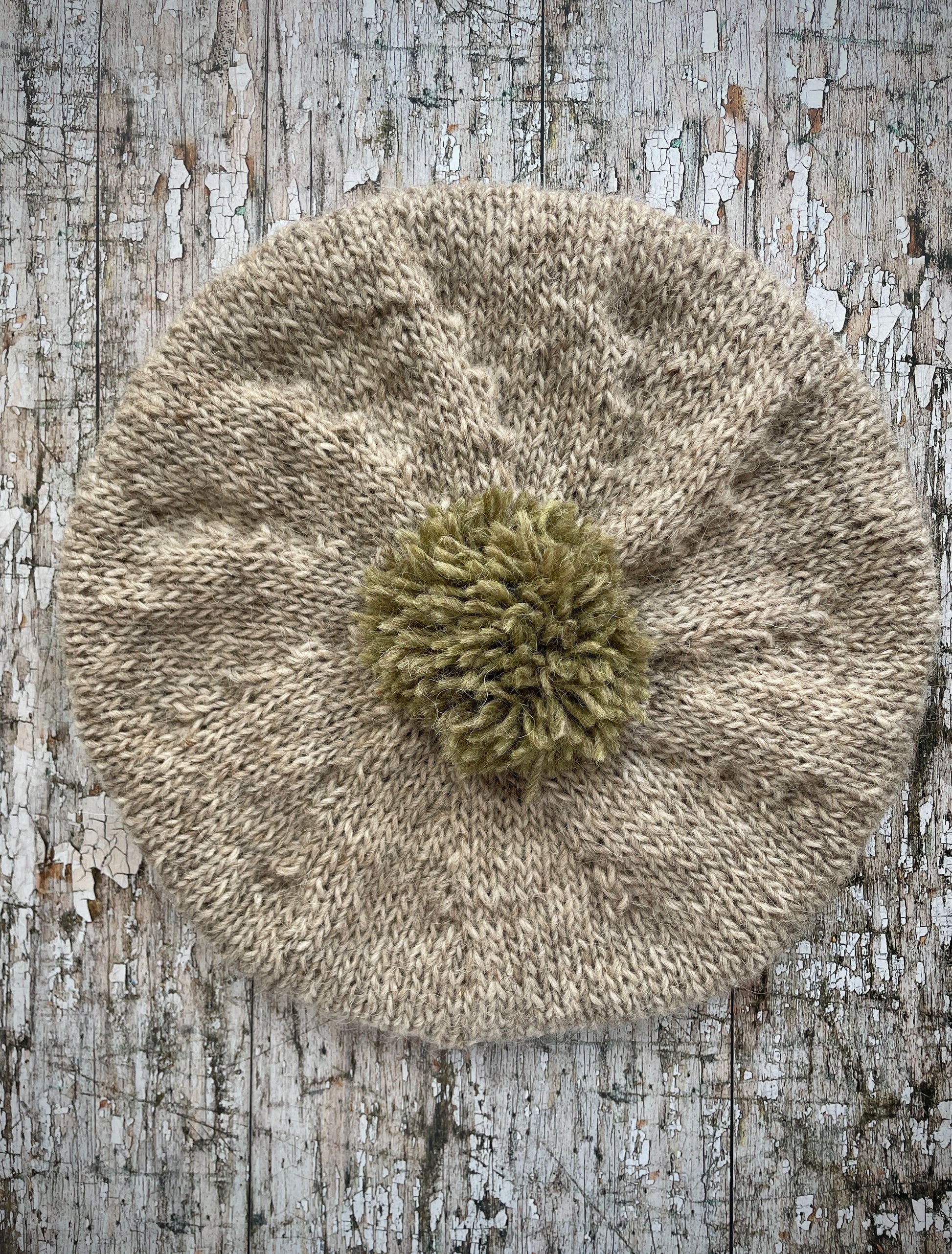Hand Knitted Wool Beret Oat + Frosted Grass

Beautifully hand knitted beret in Icelandic pure wool, perfect for keeping your head warm on cold days, knitted in oat with a frosted grass colour pom and ribbed band that gives the hat a snug fit.

SIZE: adult.

DIAMETER: 11+1/4" / 29cm.

CARE: hand wash or machine wash on wool cycle at 30 degrees, dry flat, do not tumble dry.