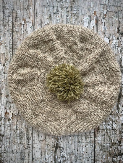 Hand Knitted Wool Beret Oat + Frosted Grass

Beautifully hand knitted beret in Icelandic pure wool, perfect for keeping your head warm on cold days, knitted in oat with a frosted grass colour pom and ribbed band that gives the hat a snug fit.

SIZE: adult.

DIAMETER: 11+1/4" / 29cm.

CARE: hand wash or machine wash on wool cycle at 30 degrees, dry flat, do not tumble dry.