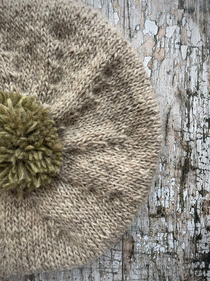 Hand Knitted Wool Beret Oat + Frosted Grass

Beautifully hand knitted beret in Icelandic pure wool, perfect for keeping your head warm on cold days, knitted in oat with a frosted grass colour pom and ribbed band that gives the hat a snug fit.

SIZE: adult.

DIAMETER: 11+1/4" / 29cm.

CARE: hand wash or machine wash on wool cycle at 30 degrees, dry flat, do not tumble dry.