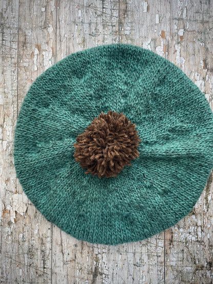 Hand Knitted Wool Beret Viridian + Dark Chocolate Brown

Beautifully hand knitted beret in Icelandic pure wool, perfect for keeping your head warm on cold days. Knitted in a lovely viridian colour with a dark chocolate brown pom and ribbed band that gives the hat a snug fit.

SIZE: adult.

DIAMETER: 11+1/4" / 28.5cm.

CARE: hand wash or machine wash on wool cycle at 30 degrees, dry flat, do not tumble dry.