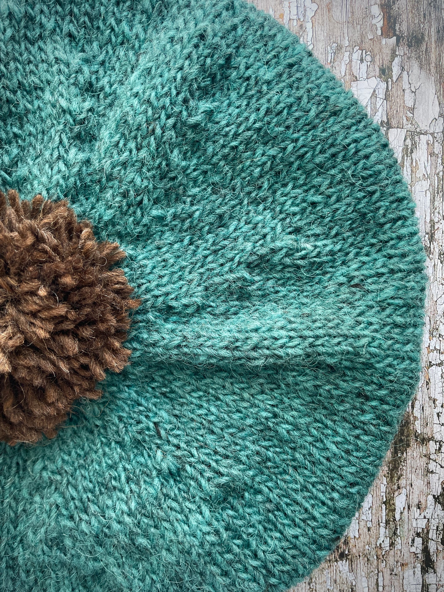 Hand Knitted Wool Beret Viridian + Dark Chocolate Brown

Beautifully hand knitted beret in Icelandic pure wool, perfect for keeping your head warm on cold days. Knitted in a lovely viridian colour with a dark chocolate brown pom and ribbed band that gives the hat a snug fit.

SIZE: adult.

DIAMETER: 11+1/4" / 28.5cm.

CARE: hand wash or machine wash on wool cycle at 30 degrees, dry flat, do not tumble dry.