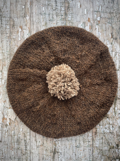 Hand Knitted Wool Beret Dark Chocolate + Dark Oat

Beautifully hand knitted beret in Icelandic pure wool, perfect for keeping your head warm on cold days. Knitted in a lovely dark chocolate brown colour with a dark oat pom and ribbed band that gives the hat a snug fit.

SIZE: adult.

DIAMETER: 11+1/2" / 29cm.

CARE: hand wash or machine wash on wool cycle at 30 degrees, dry flat, do not tumble dry.