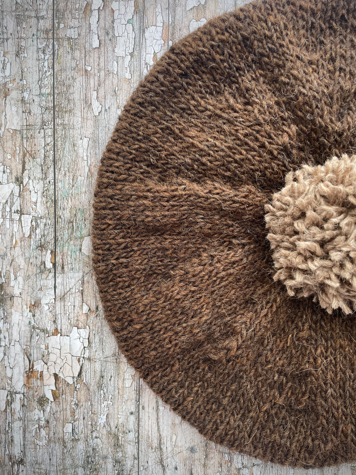 Hand Knitted Wool Beret Dark Chocolate + Dark Oat

Beautifully hand knitted beret in Icelandic pure wool, perfect for keeping your head warm on cold days. Knitted in a lovely dark chocolate brown colour with a dark oat pom and ribbed band that gives the hat a snug fit.

SIZE: adult.

DIAMETER: 11+1/2" / 29cm.

CARE: hand wash or machine wash on wool cycle at 30 degrees, dry flat, do not tumble dry.