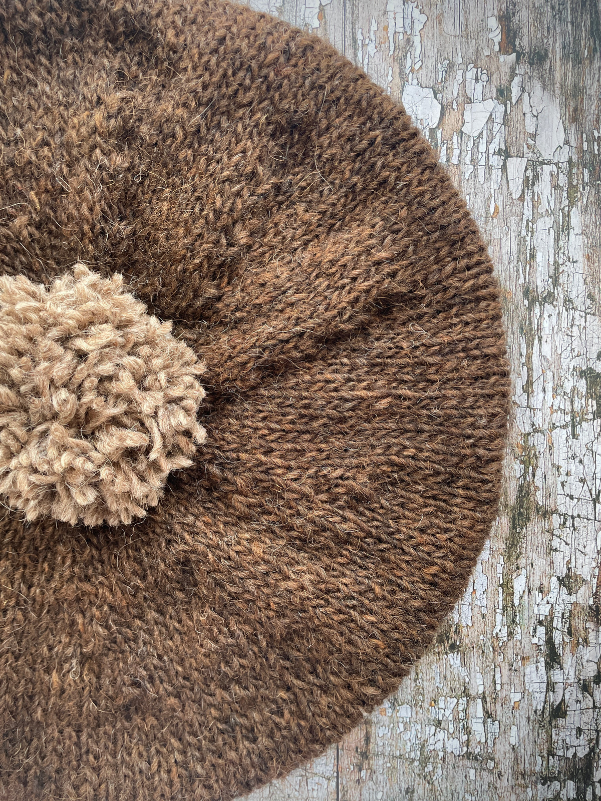 Hand Knitted Wool Beret Dark Chocolate + Dark Oat

Beautifully hand knitted beret in Icelandic pure wool, perfect for keeping your head warm on cold days. Knitted in a lovely dark chocolate brown colour with a dark oat pom and ribbed band that gives the hat a snug fit.

SIZE: adult.

DIAMETER: 11+1/2" / 29cm.

CARE: hand wash or machine wash on wool cycle at 30 degrees, dry flat, do not tumble dry.