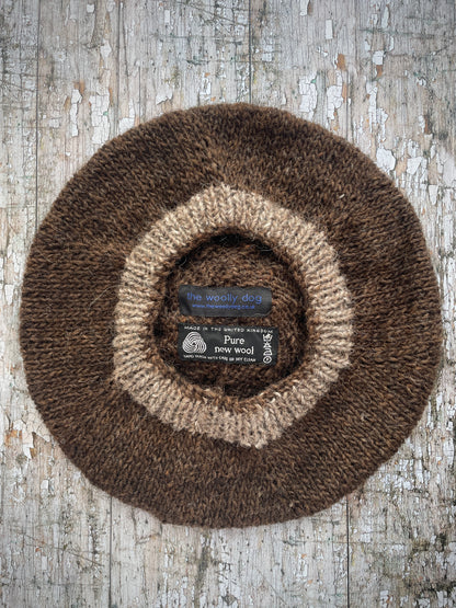 Hand Knitted Wool Beret Dark Chocolate + Dark Oat

Beautifully hand knitted beret in Icelandic pure wool, perfect for keeping your head warm on cold days. Knitted in a lovely dark chocolate brown colour with a dark oat pom and ribbed band that gives the hat a snug fit.

SIZE: adult.

DIAMETER: 11+1/2" / 29cm.

CARE: hand wash or machine wash on wool cycle at 30 degrees, dry flat, do not tumble dry.