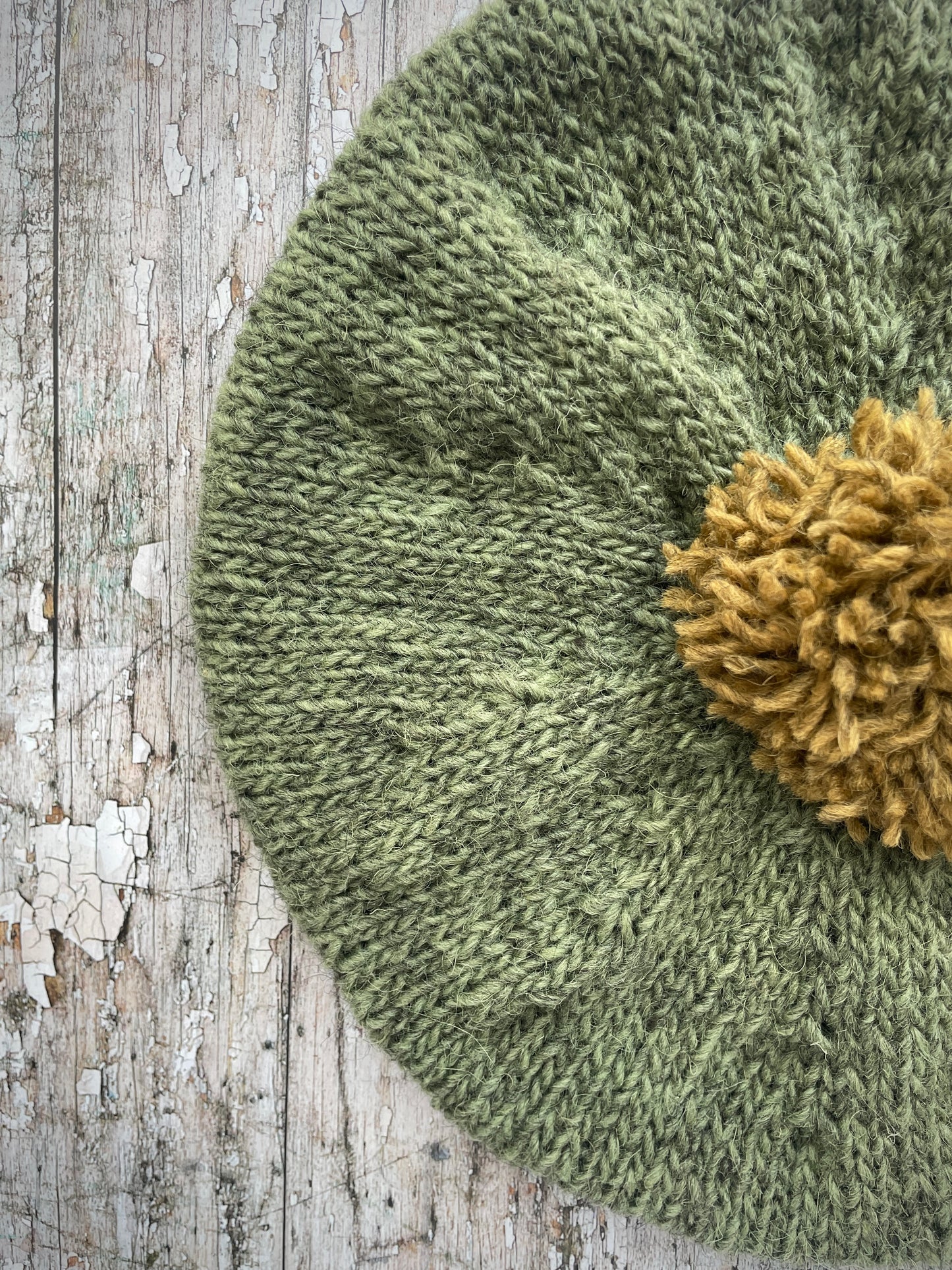 Hand Knitted Wool Beret Olive + Dark Kelp

Beautifully hand knitted beret in Icelandic pure wool, perfect for keeping your head warm on cold days, knitted in olive with a dark kelp colour pom and ribbed band that gives the hat a snug fit.

SIZE: adult.

DIAMETER: 11+1/2" / 29.5 cm.

CARE: hand wash or machine wash on wool cycle at 30 degrees, dry flat, do not tumble dry.