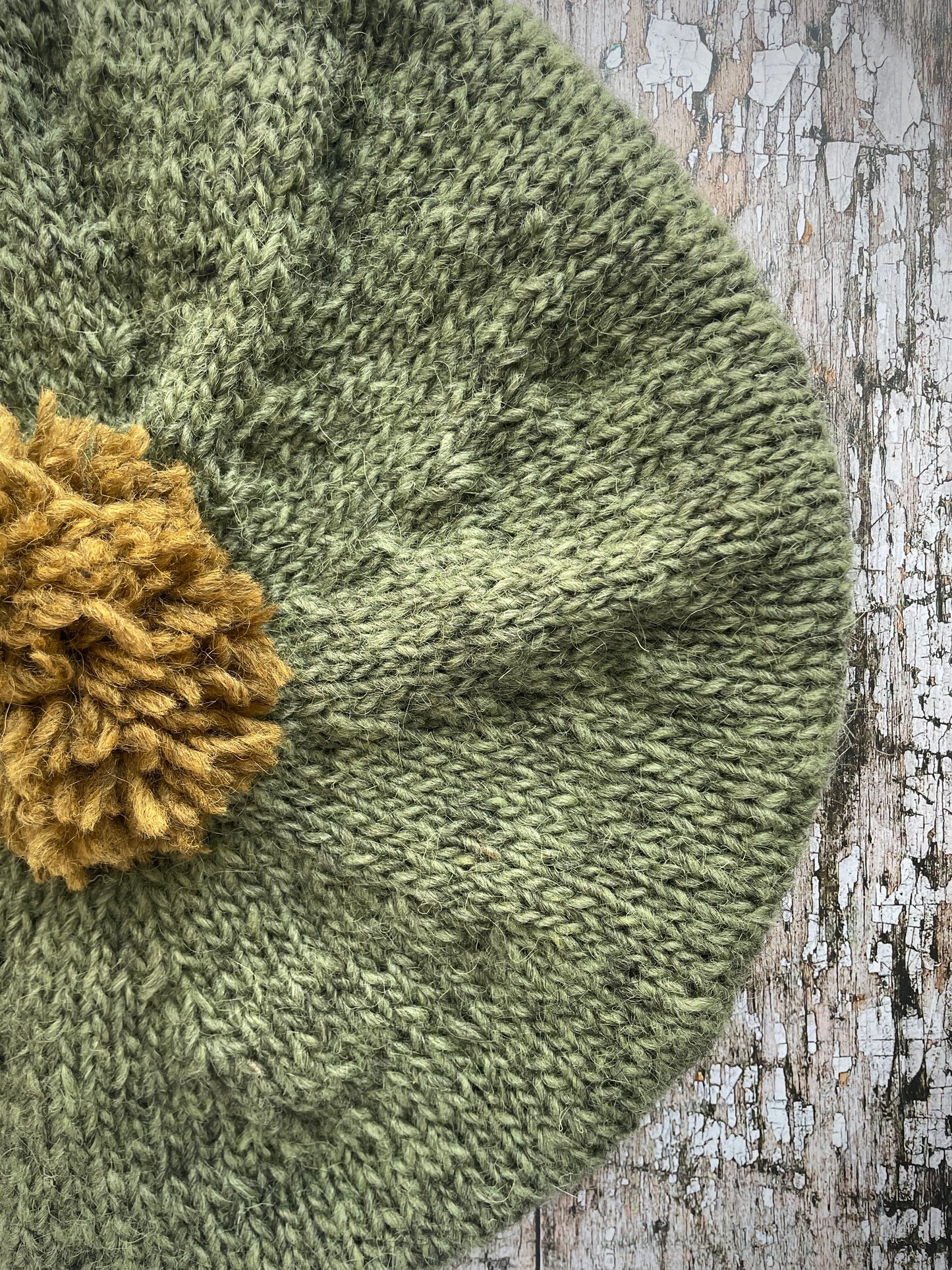 Hand Knitted Wool Beret Olive + Dark Kelp

Beautifully hand knitted beret in Icelandic pure wool, perfect for keeping your head warm on cold days, knitted in olive with a dark kelp colour pom and ribbed band that gives the hat a snug fit.

SIZE: adult.

DIAMETER: 11+1/2" / 29.5 cm.

CARE: hand wash or machine wash on wool cycle at 30 degrees, dry flat, do not tumble dry.