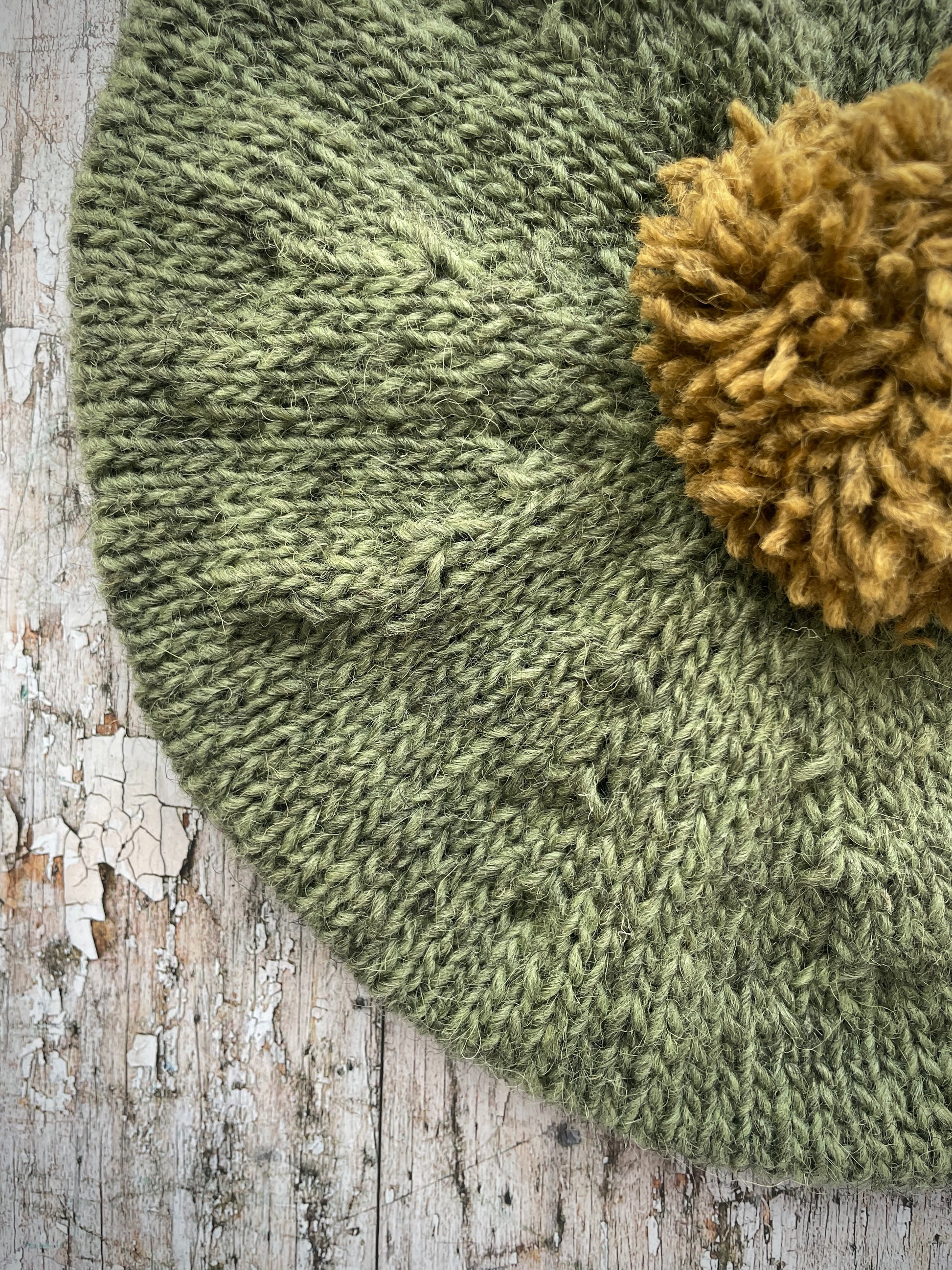 Hand Knitted Wool Beret Olive + Dark Kelp

Beautifully hand knitted beret in Icelandic pure wool, perfect for keeping your head warm on cold days, knitted in olive with a dark kelp colour pom and ribbed band that gives the hat a snug fit.

SIZE: adult.

DIAMETER: 11+1/2" / 29.5 cm.

CARE: hand wash or machine wash on wool cycle at 30 degrees, dry flat, do not tumble dry.
