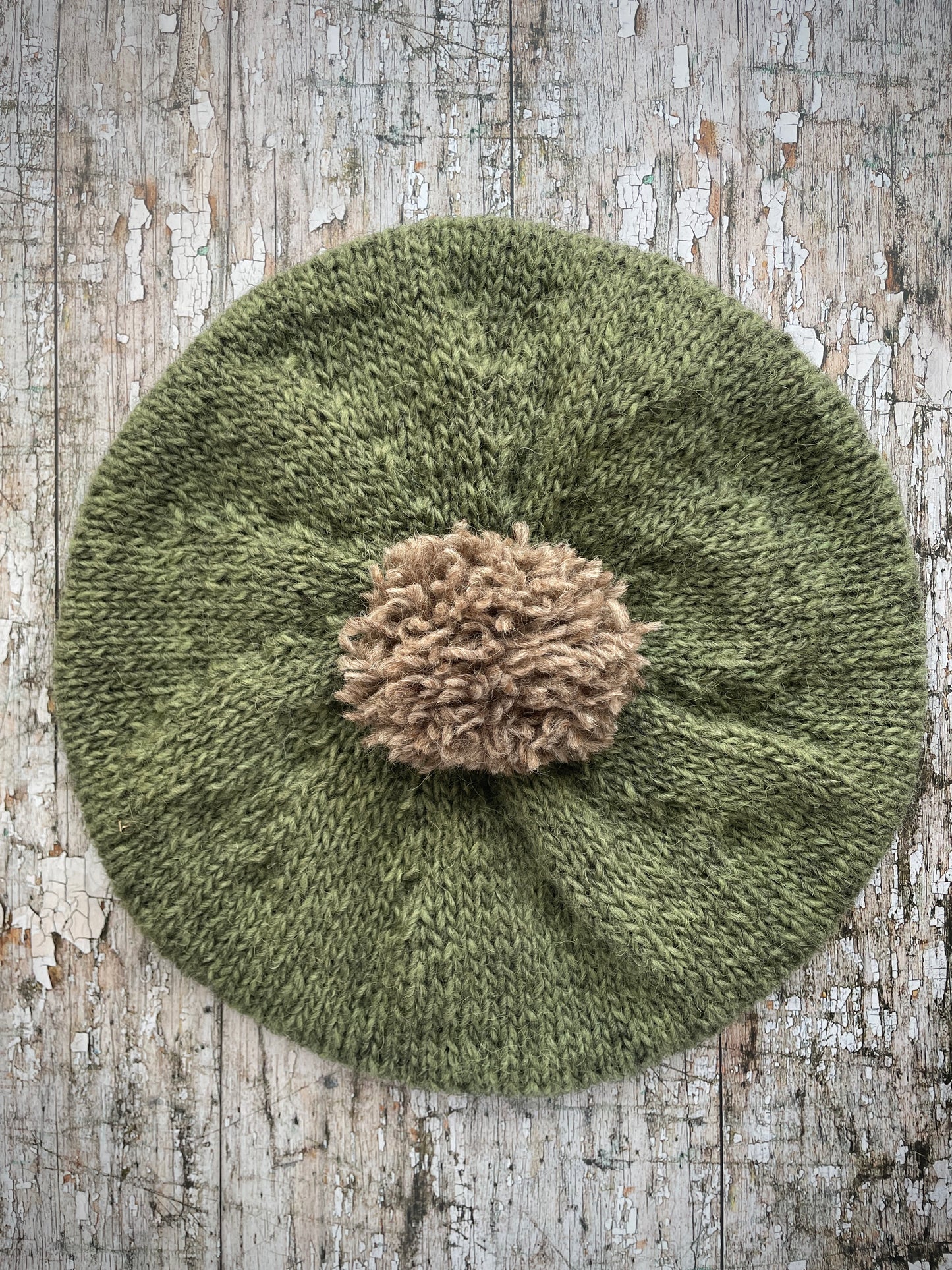 Hand Knitted Wool Beret Olive + Dark Oat

Beautifully hand knitted beret in Icelandic pure wool, perfect for keeping your head warm on cold days, knitted in olive with a dark oat colour pom and ribbed band that gives the hat a snug fit.

SIZE: adult.

DIAMETER: 11" / 28 cm.

CARE: hand wash or machine wash on wool cycle at 30 degrees, dry flat, do not tumble dry.