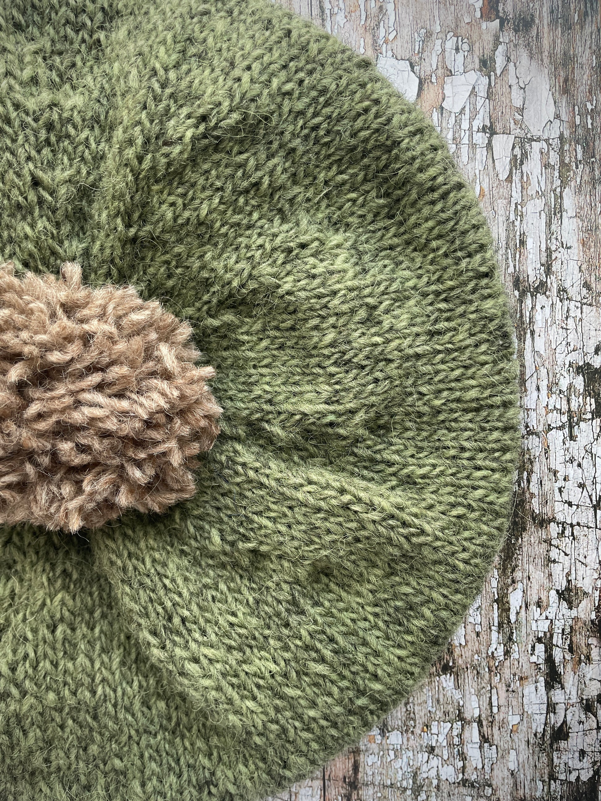 Hand Knitted Wool Beret Olive + Dark Oat

Beautifully hand knitted beret in Icelandic pure wool, perfect for keeping your head warm on cold days, knitted in olive with a dark oat colour pom and ribbed band that gives the hat a snug fit.

SIZE: adult.

DIAMETER: 11" / 28 cm.

CARE: hand wash or machine wash on wool cycle at 30 degrees, dry flat, do not tumble dry.