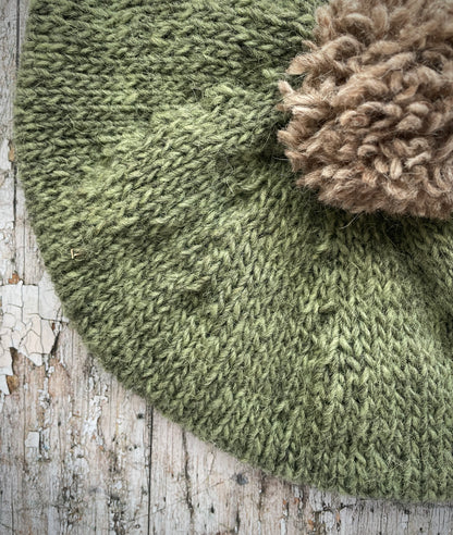 Hand Knitted Wool Beret Olive + Dark Oat

Beautifully hand knitted beret in Icelandic pure wool, perfect for keeping your head warm on cold days, knitted in olive with a dark oat colour pom and ribbed band that gives the hat a snug fit.

SIZE: adult.

DIAMETER: 11" / 28 cm.

CARE: hand wash or machine wash on wool cycle at 30 degrees, dry flat, do not tumble dry.