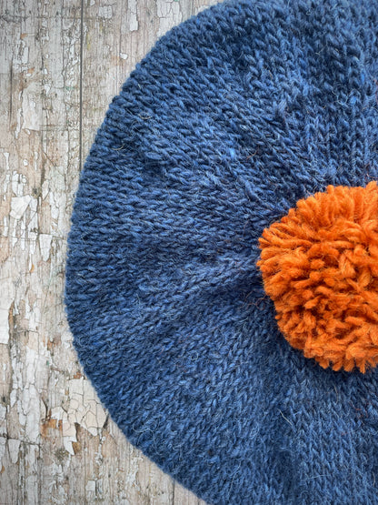 Hand Knitted Wool Beret Indigo Blue + Burnt Orange

Beautifully hand knitted beret in Icelandic pure wool, perfect for keeping your head warm on cold days, knitted in indigo with a burnt orange colour pom and ribbed band that gives the hat a snug fit.

SIZE: adult.

DIAMETER: 11+1/4" / 28 cm.

CARE: hand wash or machine wash on wool cycle at 30 degrees, dry flat, do not tumble dry.