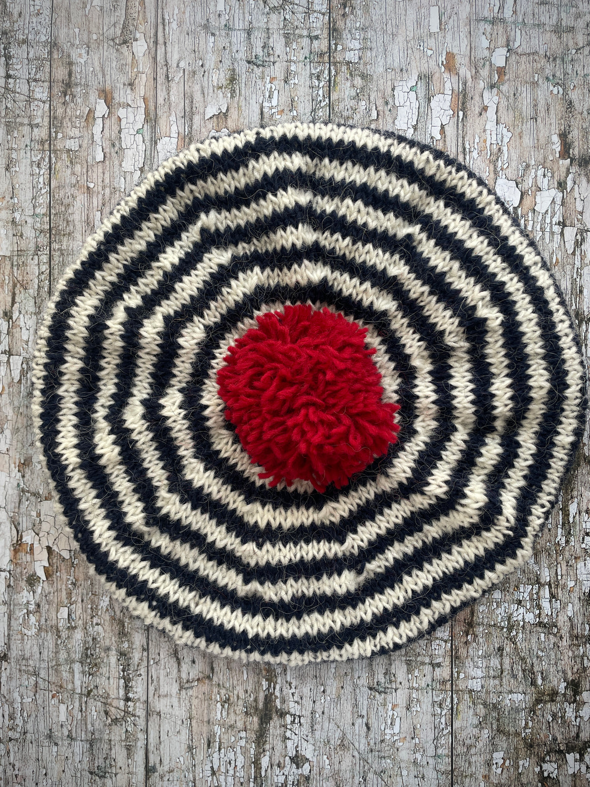 Navy Blue + White + Red Breton Stripes Wool Beret

Nautical style beret, beautifully hand knitted with Icelandic pure new wool, in Breton stripes of navy blue and white, with a big red pom and a navy blue ribbed band that gives the hat a snug fit. Perfect for keeping your head warm on cold days.

SIZE: adult.

DIAMETER: 11+1/2" / 29 cm.

CARE: hand wash or machine wash on wool cycle at 30 degrees, dry flat, do not tumble dry.