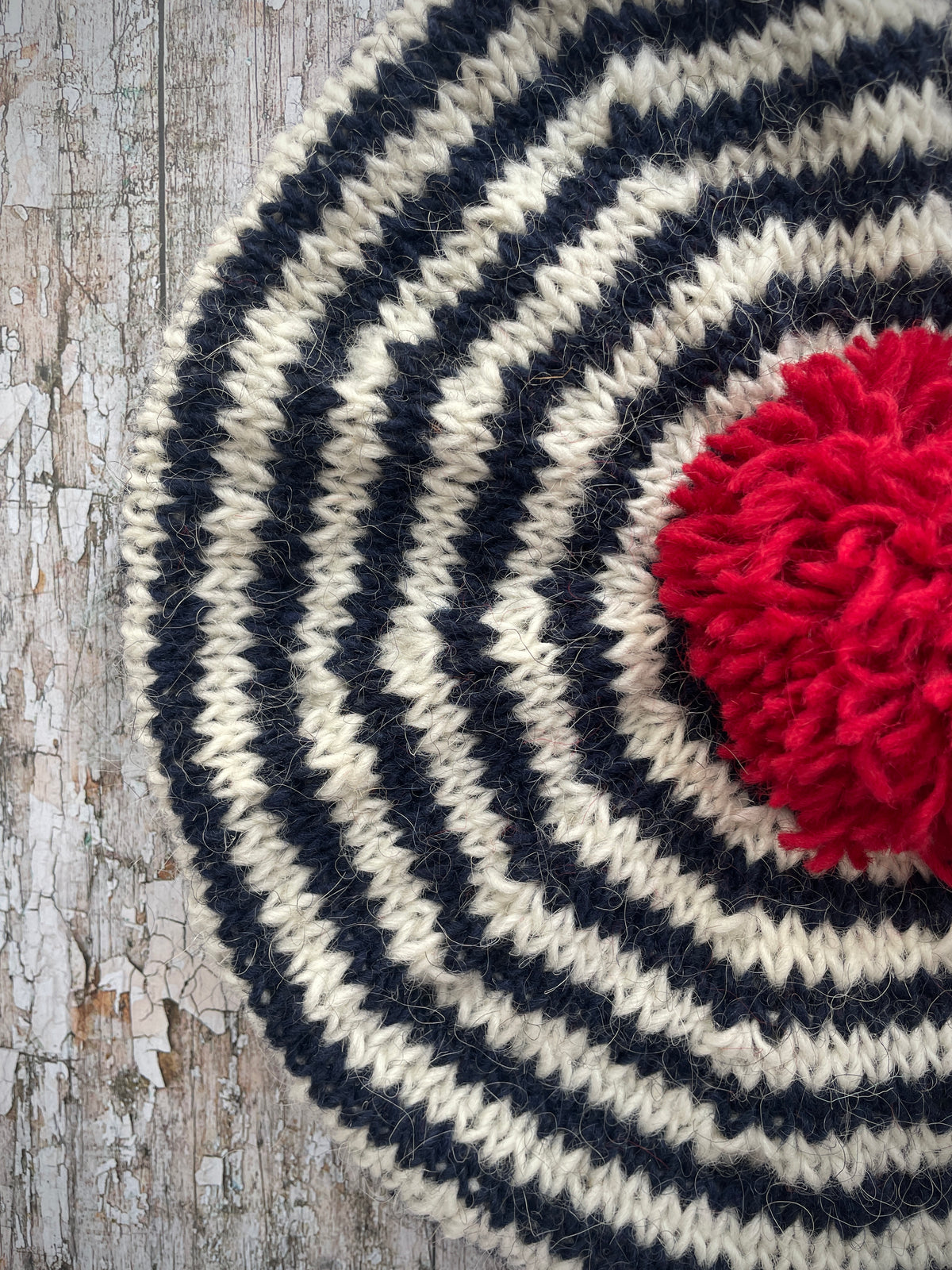 Navy Blue + White + Red Breton Stripes Wool Beret

Nautical style beret, beautifully hand knitted with Icelandic pure new wool, in Breton stripes of navy blue and white, with a big red pom and a navy blue ribbed band that gives the hat a snug fit. Perfect for keeping your head warm on cold days.

SIZE: adult.

DIAMETER: 11+1/2" / 29 cm.

CARE: hand wash or machine wash on wool cycle at 30 degrees, dry flat, do not tumble dry.