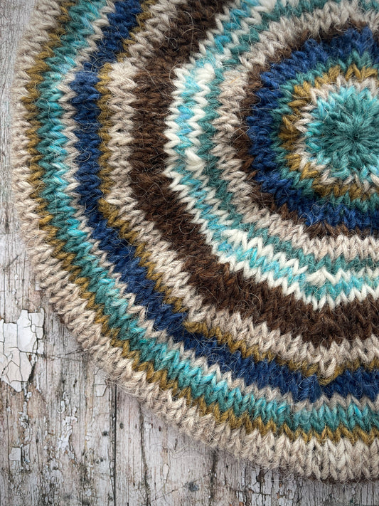 Classic 40's Style Beret no.14
Beautifully hand knitted beret in Icelandic wool, perfect for keeping your head warm on cold days and adding a touch of 40's style to any outfit. Knitted in dark chocolate brown, indigo blue, oat, white, aqua heather, dark kelp and viridian stripes, with a dark chocolate brown ribbed band that gives the hat a snug fit.

SIZE: adult.

DIAMETER: 11+1/4" / 28.5cm.

CARE: hand wash or machine wash on wool cycle at 30 degrees, dry flat, do not tumble dry.