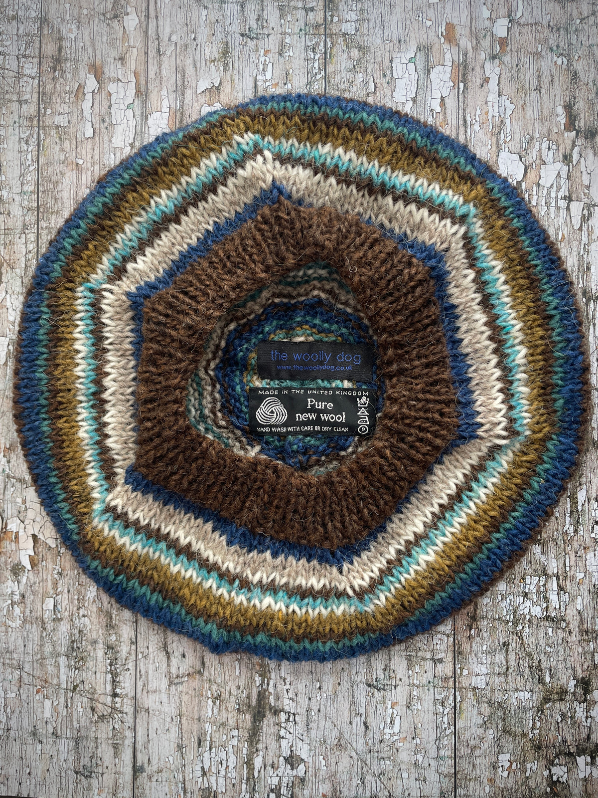 Classic 40's Style Beret no.14
Beautifully hand knitted beret in Icelandic wool, perfect for keeping your head warm on cold days and adding a touch of 40's style to any outfit. Knitted in dark chocolate brown, indigo blue, oat, white, aqua heather, dark kelp and viridian stripes, with a dark chocolate brown ribbed band that gives the hat a snug fit.

SIZE: adult.

DIAMETER: 11+1/4" / 28.5cm.

CARE: hand wash or machine wash on wool cycle at 30 degrees, dry flat, do not tumble dry.