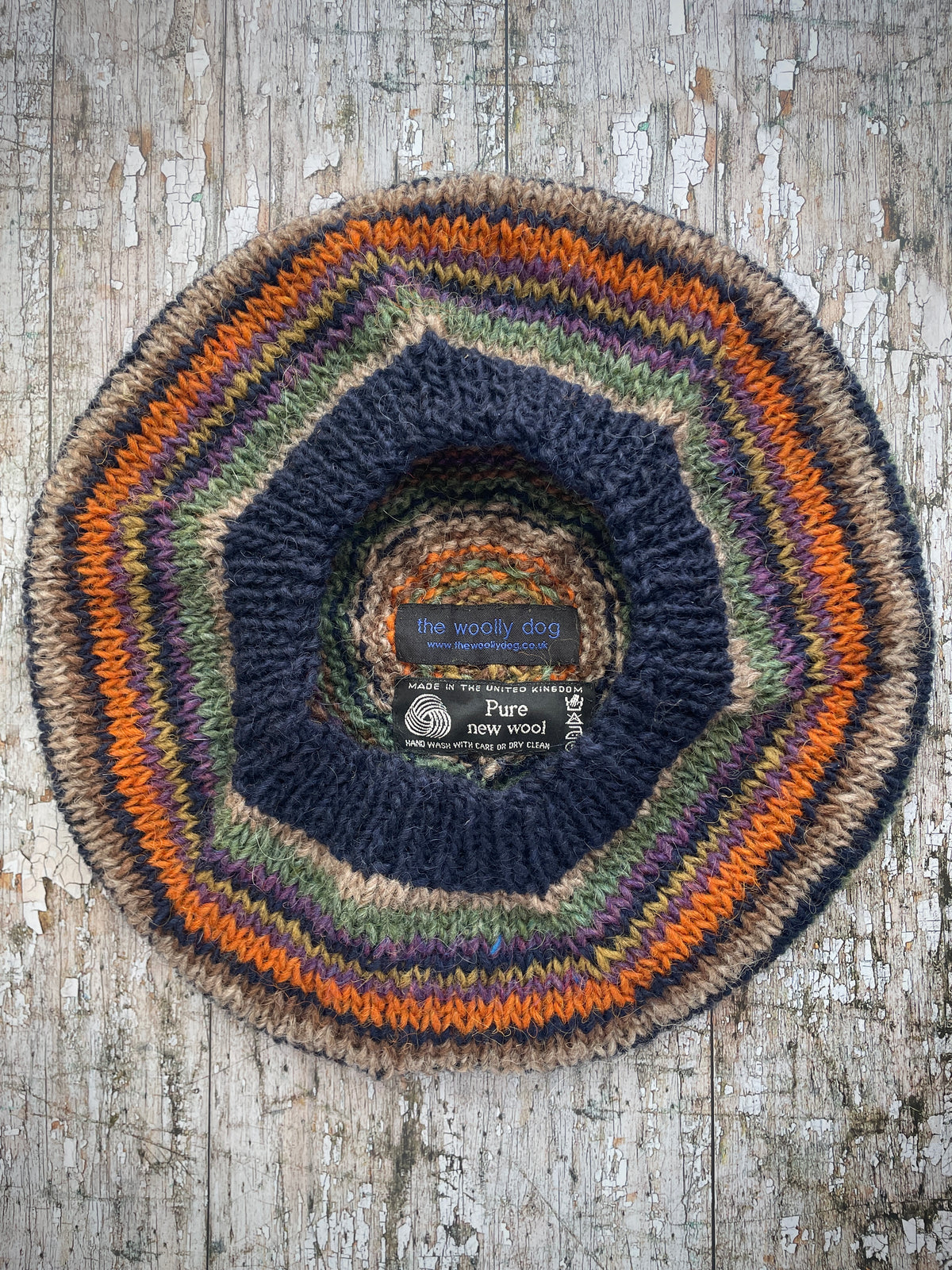 Classic 40's Style Beret no.7
Beautifully hand knitted beret in Icelandic wool, perfect for keeping your head warm on cold days and adding a touch of 40's style to any outfit. Knitted in navy, dark oat, sage, violet heather, dark kelp, burnt burnt orange and milk chocolate brown stripes, with a navy ribbed band that gives the hat a snug fit.

SIZE: adult.

DIAMETER: 11+1/2" / 29cm.

CARE: hand wash or machine wash on wool cycle at 30 degrees, dry flat, do not tumble dry.
