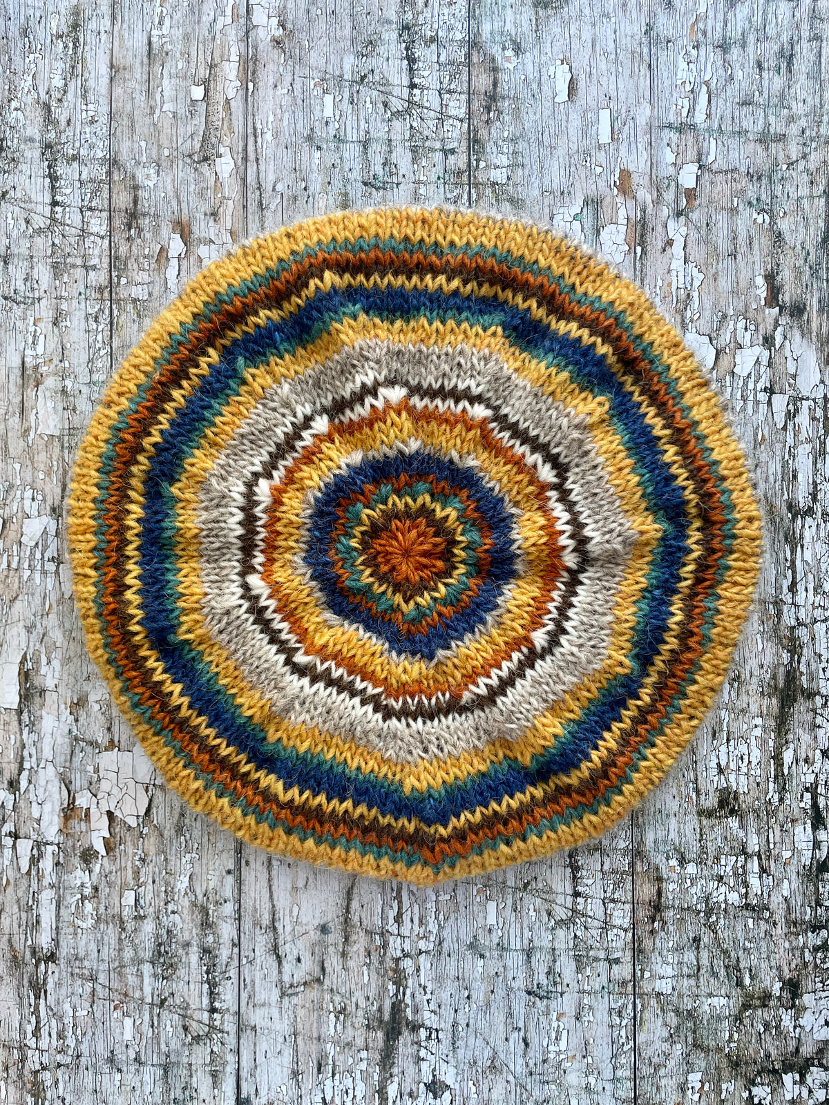 Classic 40's Style Beret no.4

Beautifully hand knitted beret in Icelandic Lettlopi wool, perfect for keeping your head warm on cold days and adding a touch of 40's style to any outfit. Knitted in oat, indigo blue, mustard, white, dark chocolate brown, viridian and burorange stripes, with an oat ribbed band that gives the hat a snug fit.

SIZE: adult.
DIAMETER: 11" / 28cm.

CARE: hand wash or machine wash on wool cycle at 30 degrees, dry flat, do not tumble dry.