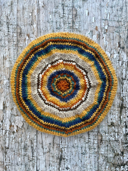 Classic 40's Style Beret no.4

Beautifully hand knitted beret in Icelandic Lettlopi wool, perfect for keeping your head warm on cold days and adding a touch of 40's style to any outfit. Knitted in oat, indigo blue, mustard, white, dark chocolate brown, viridian and burorange stripes, with an oat ribbed band that gives the hat a snug fit.

SIZE: adult.
DIAMETER: 11" / 28cm.

CARE: hand wash or machine wash on wool cycle at 30 degrees, dry flat, do not tumble dry.
